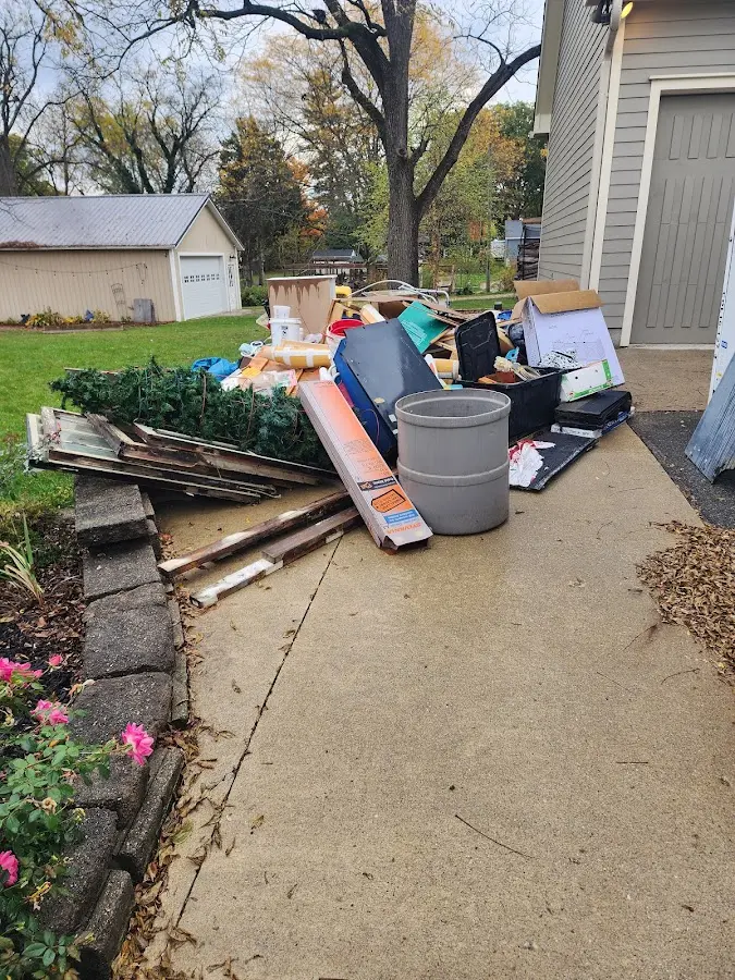 Dumpster being loaded with debris for 30 Yard Dumpster Rental in Americus